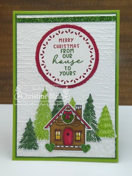 a christmas card with a house and trees