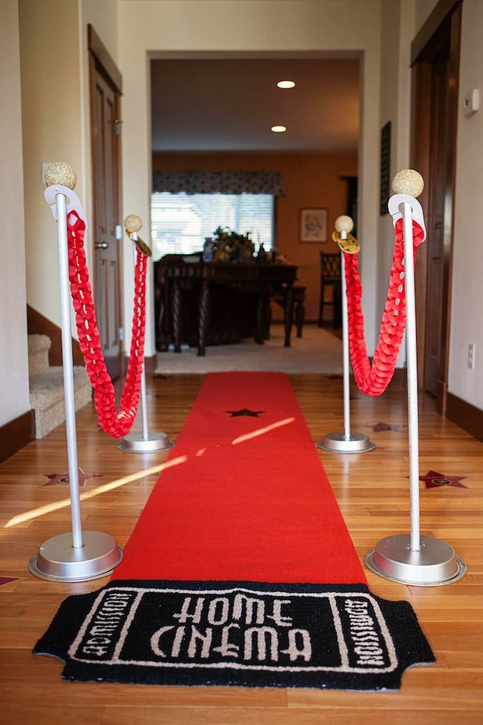 a red carpet and some white poles on the ground