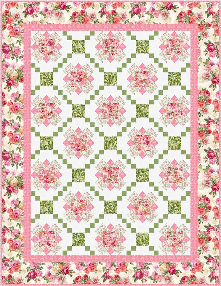 a pink and green quilt with flowers on the border, in front of a white background