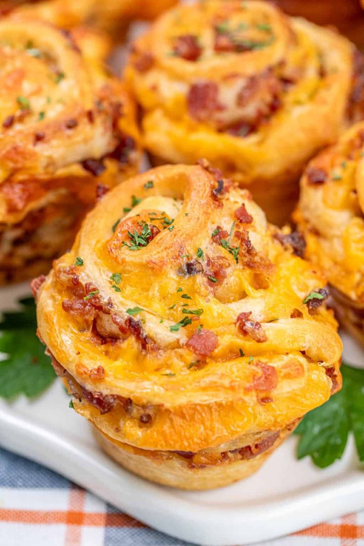 several mini pizzas on a plate with parsley