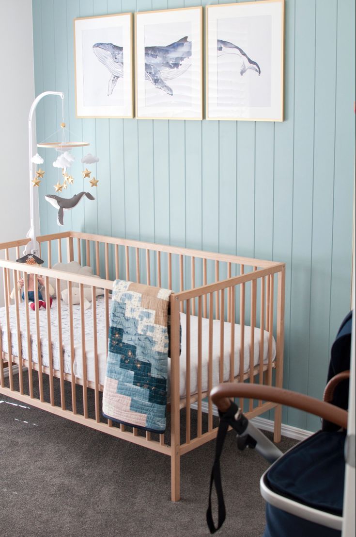 a baby's crib in a blue and white nursery