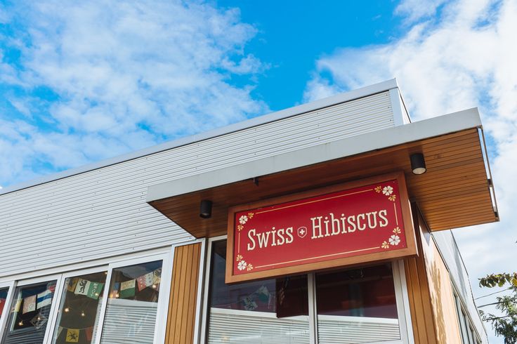 a store front with the sign swiss - hirsus on it's side