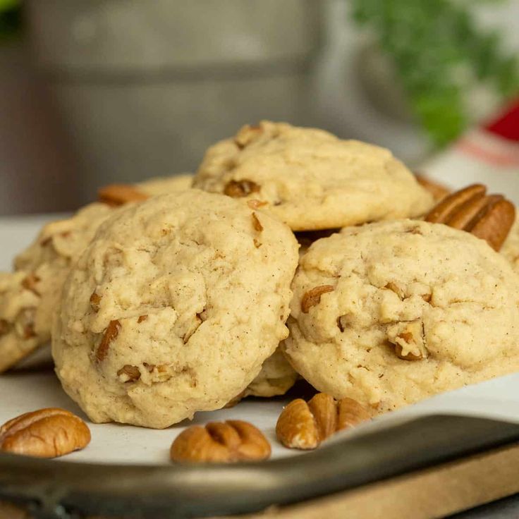 some pecans and cookies are on a plate