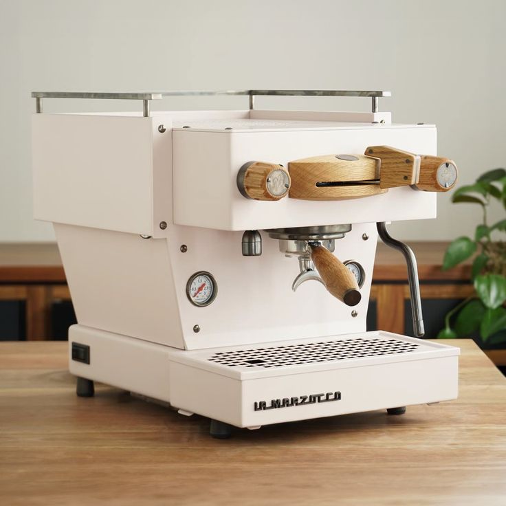 an espresso machine sitting on top of a wooden table