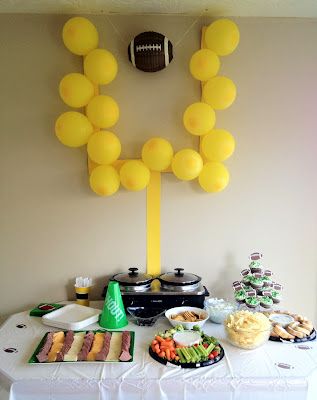 a football themed party with balloons and food