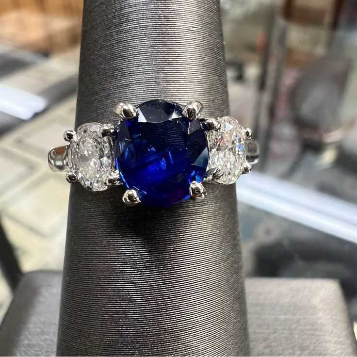 a blue ring with three diamonds on it