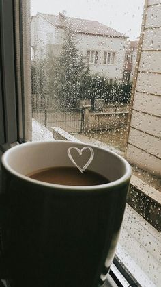 a cup of coffee sitting on top of a window sill