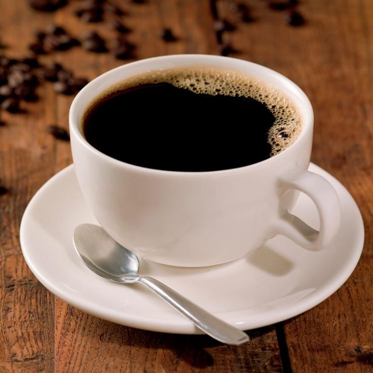 a cup of coffee sitting on top of a white saucer