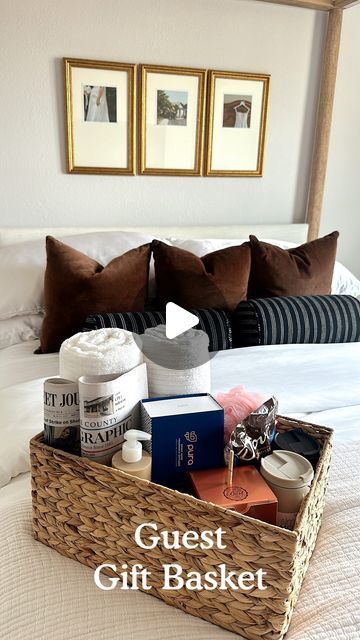 the guest gift basket is on top of the bed with two framed pictures above it