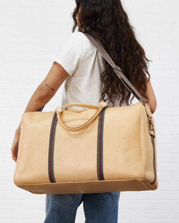 Our largest duffel style, the Weekender, is our go-to for weekends and day trips on the go. This duffel is roomy enough for all your essentials and features leather handles, an adjustable crossbody length webbing strap, two interior pockets, and two exterior pockets. If you’re looking for a TSA carry-on compatible bag, check out the Jetsetter or the Zipper Tote! -Deigo natural leather exterior -Zipper closure -Interior zipper and slide pocket, and two exterior slide pockets -Natural leather hand On-the-go Travel Bag With Leather Trim And Double Handle, Weekend Tote Duffle Bag With Leather Handles, Weekend Duffle Bag With Leather Handles, Everyday Rectangular Duffle Bag With Leather Handles, Rectangular Duffle Bag With Leather Handles, Leather Handle Tote Duffle Bag For Weekend Trips, Rectangular Duffle Bag With Leather Trim For Weekend Trips, Everyday Rectangular Duffle Bag With Leather Trim, Leather-handled Duffle Bag For Weekend Trips