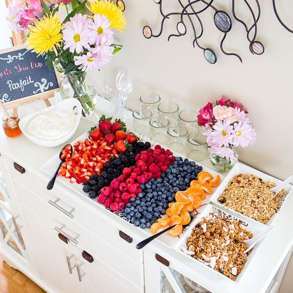 an assortment of fruits and cereals on a buffet table