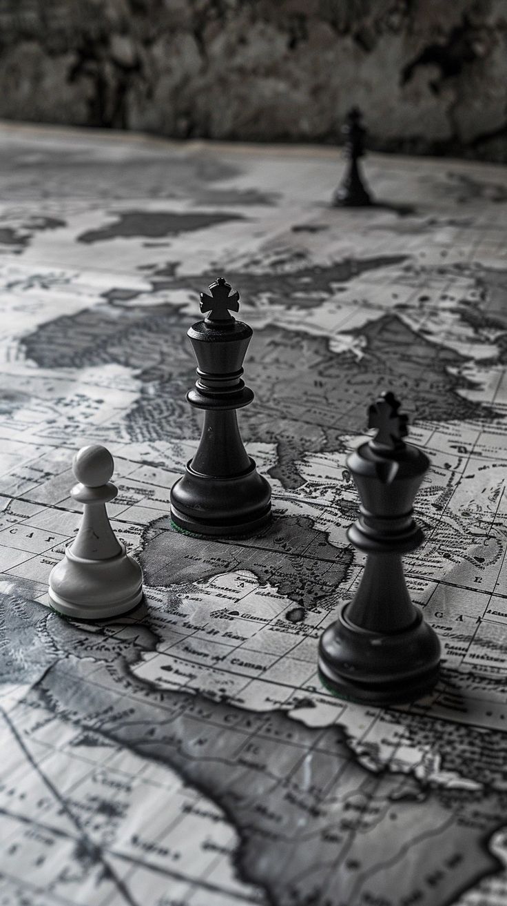 a group of chess pieces sitting on top of a map covered table next to each other