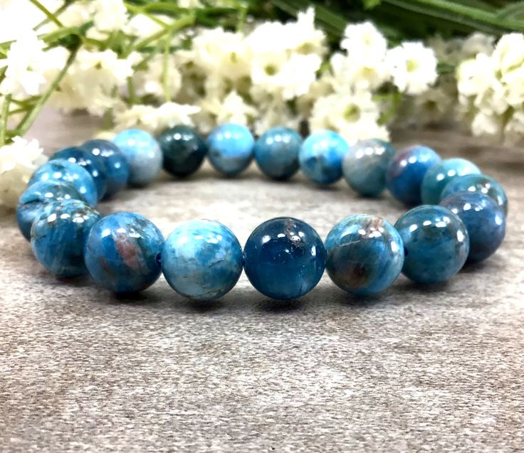 ✦Gemstone: Natural Apatite ✦Color: blue ✦Shape: Round  ✦Length: 5''-9'' ✦Bead Size: 10mm ✦QTY: 1 pc / package ✦✦Please measure your wrist size, then order the bracelet. Apatite is a stone of manifestation. It is related to service and to humanitarian pursuits. ... Apatite enhances creativity and the intellect. It clears confusion and frustration, reducing irritability and awakening the inner self. Apatite expands knowledge and truth and eases sorrow, apathy, and anger. Color may vary slightly due to your monitors' color calibration settings. Please allow 0.2-0.5mm measurement error due to different measurement manner. PLEASE feel free to contact us, if you have WHOLESALE QUERY OR ANY OTHER QUESTION Thanks for your kindly understand! Apatite Bracelet, Chinese Bracelet, Healing Gemstone Bracelets, Reiki Jewelry, Amazonite Bracelet, Crystal Healing Bracelets, Bracelet Blue, Blue Apatite, Bracelets Handmade Beaded