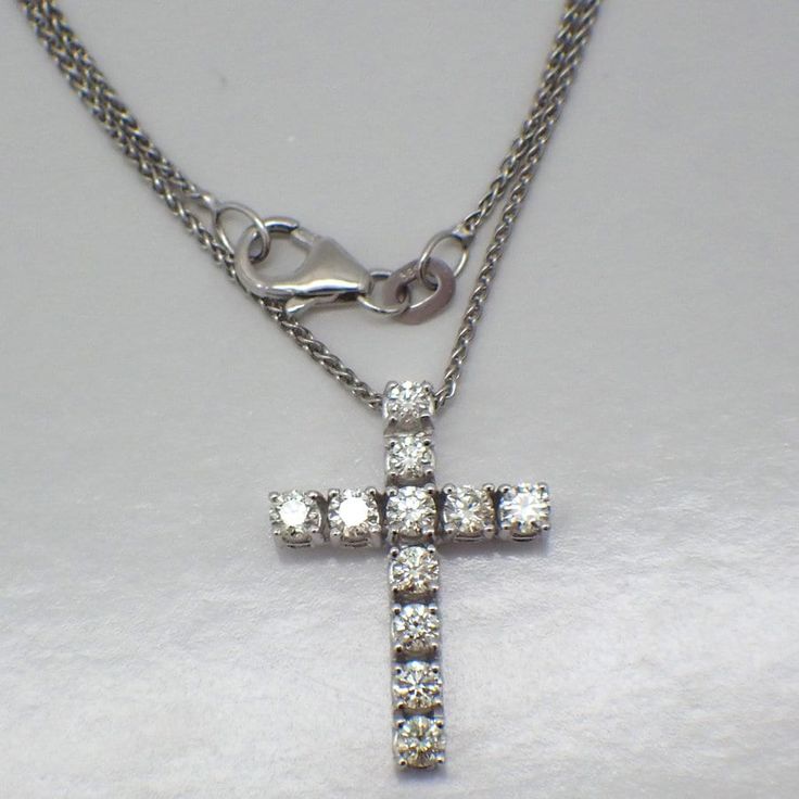 Vintage 14k (.585) white gold chain necklace with a cross pendant, decorated with Diamonds - approx. 0.7tcw, SI1-SI2 clarity, color J-K. This darling cross is 21 mm x 15 mm, the chain is 17 7/8" long and 1 mm wide, total weight is 3.7 grams. EA5027 White Diamond-cut Pendant Cross Necklace, White Diamond Cut Pendant Cross Necklace, White Gold Crucifix Necklace For Formal Occasions, White Gold Crucifix Necklace With Vvs Clarity, White Diamond Crucifix Necklace, White Crucifix Cross Necklace With Brilliant Cut, White Diamond Cross Necklace Fine Jewelry, Fine Jewelry White Diamond Cross Necklace, White Cross Diamond Necklace Fine Jewelry