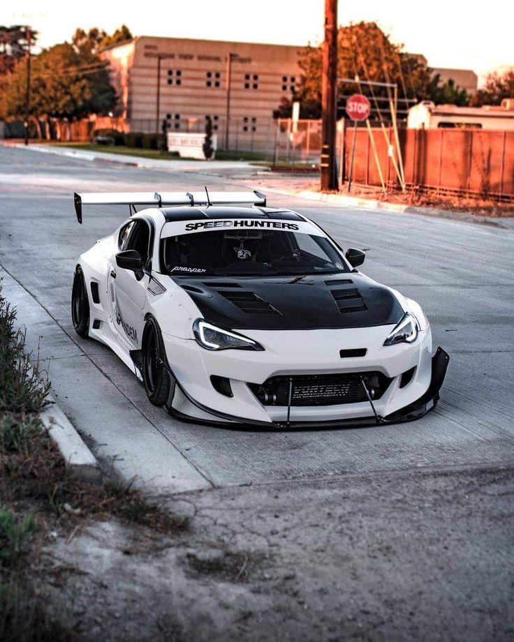 a white and black sports car parked on the street