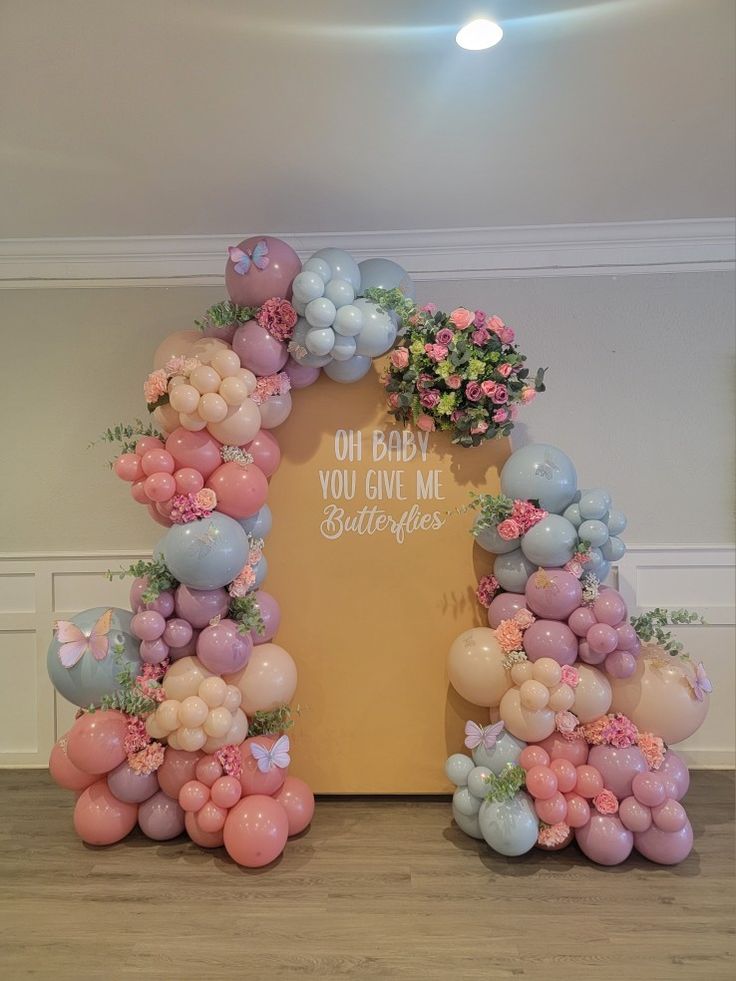 Butterfly baby shower with florals Spring Ballon Decoration, Two Arch Backdrop With Balloons, Fairy Theme Balloon Garland, Butterfly Balloon Decor, Butterfly Baby Shower Balloon Garland, Flowers In Balloon Garland, Balloon And Floral Arch, Enchanted Garden Balloon Garland, Balloon Garlands With Flowers