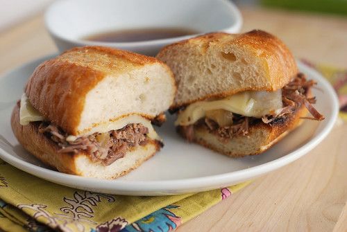 a sandwich cut in half sitting on top of a white plate