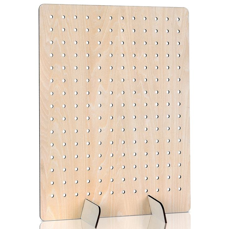 a wooden peg board with two metal hooks on the front and one has holes in it