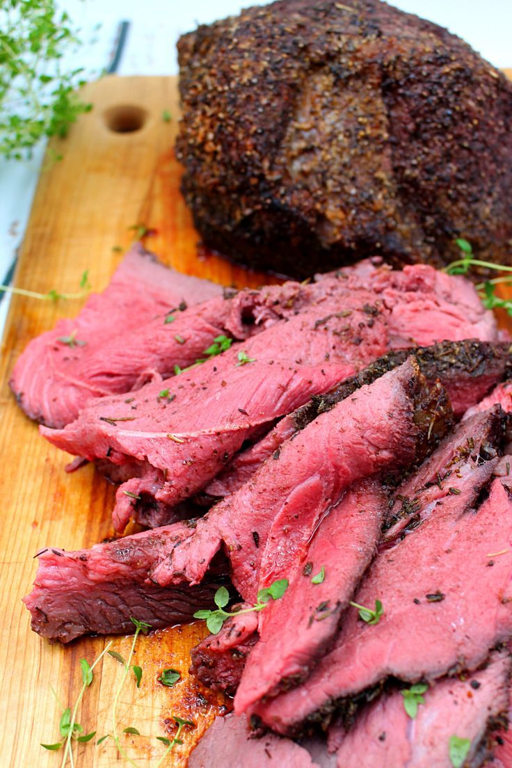 the meat is cut up and ready to be eaten on the cutting board with parsley