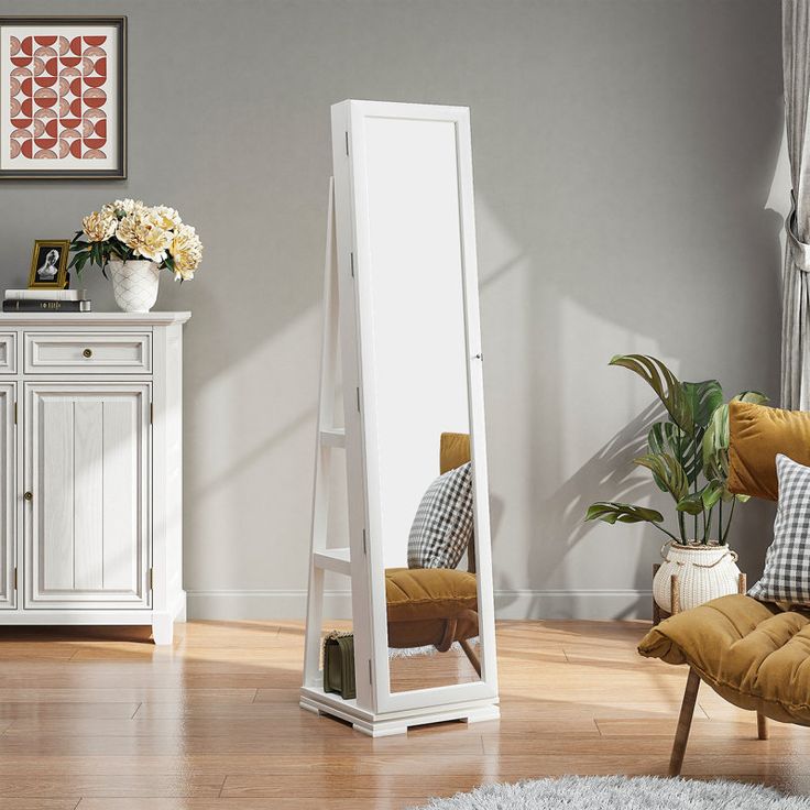 a white floor standing mirror in a living room