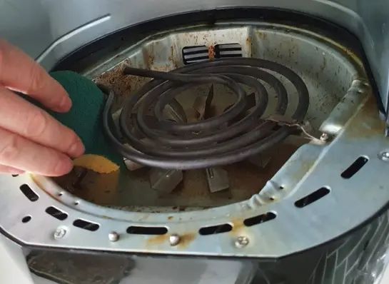 a person is cleaning the inside of an oven