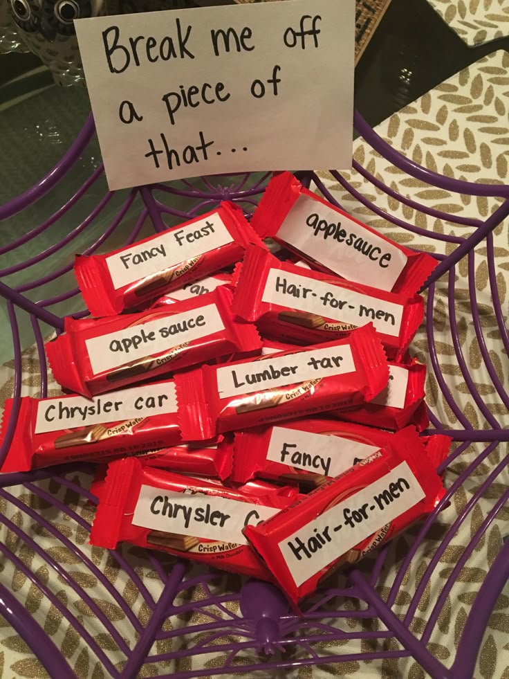 a pile of candy bars sitting on top of a purple tray with a sign that reads break me off a piece of that