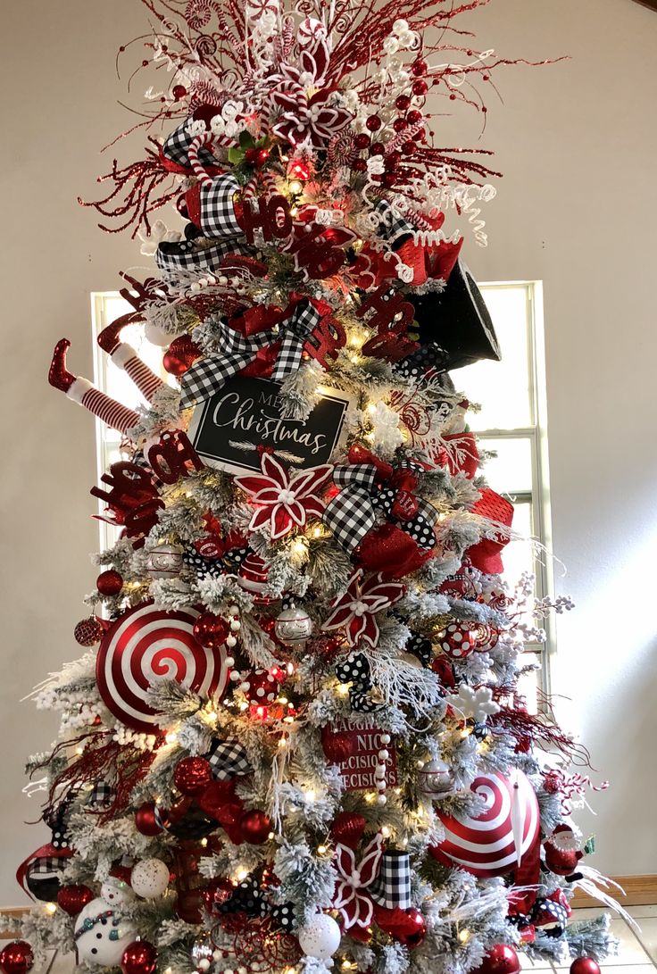 a christmas tree decorated with red, white and black ornaments