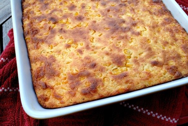 a casserole in a white dish on top of a red and white towel