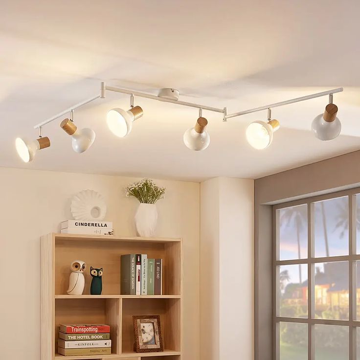 a living room filled with furniture and lots of lights on top of the book shelves