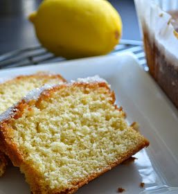 two slices of cake on a plate with lemons in the backgroung