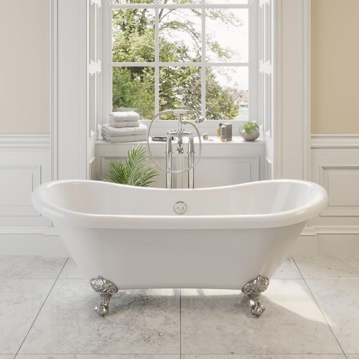 a white bath tub sitting next to a window