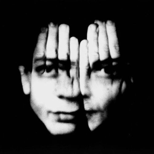 black and white photograph of a person holding their hands to their face with both hands