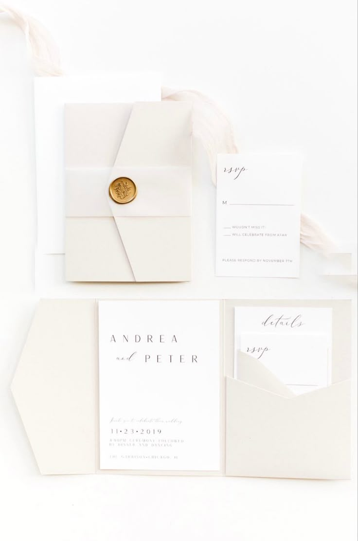 the wedding stationery is laid out on top of each other