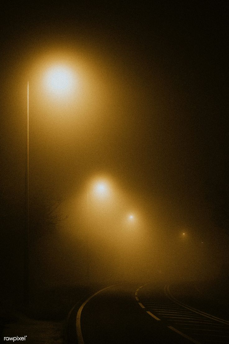 three street lights on a foggy night