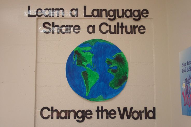 a sign on the wall that says learn a language share a culture change the world