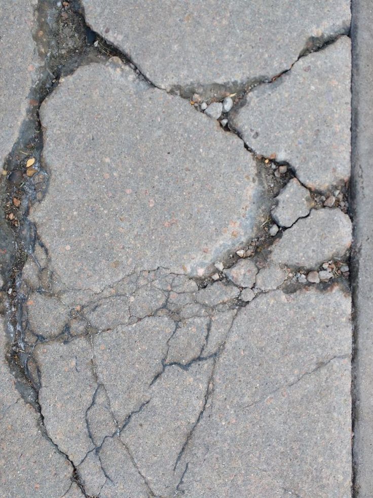 the sidewalk has cracks in it and is cracked