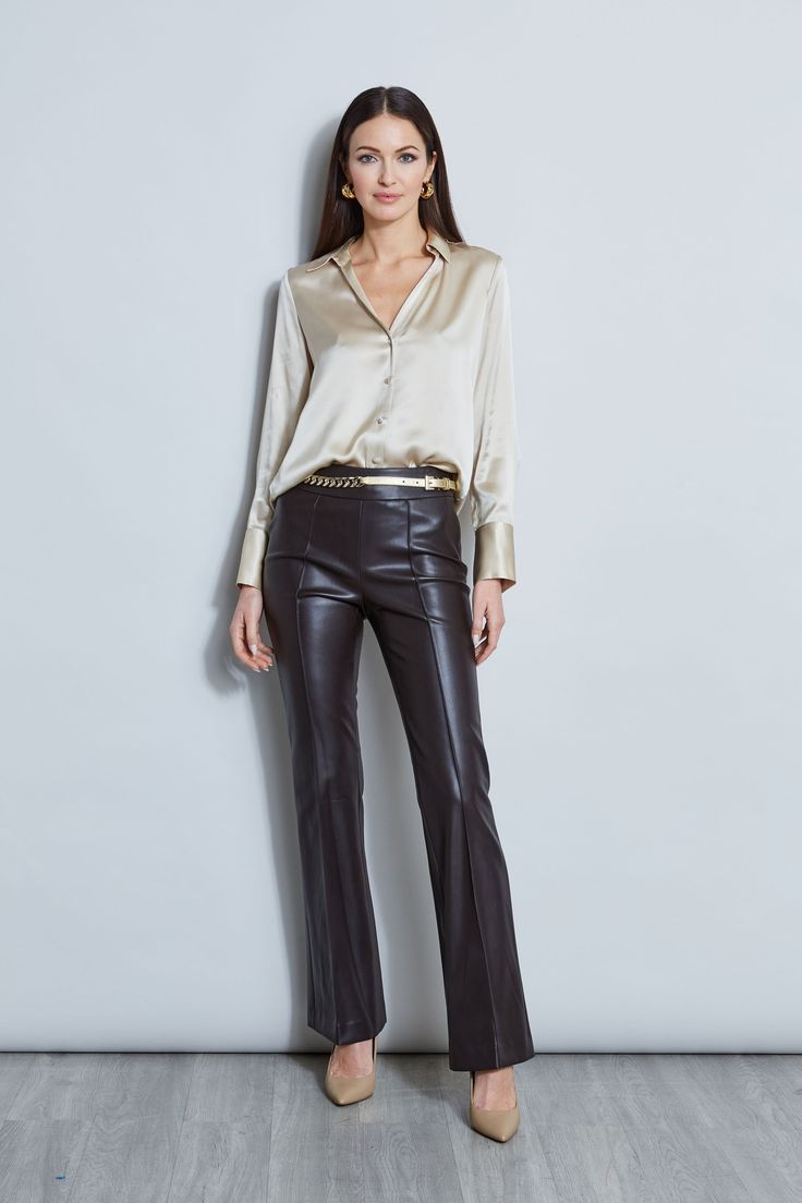 Nothing beats the chic factor and luxe patina of a Silk Satin shirt. Our button-down design features a v-neckline that is perfect for layering under a blazer or wearing on its own- you will live in this shirt all season long. Elie Tahari Exclusive Long Sleeve Silk Satin Button Down shirt 100% Silk Relaxed Fit; Runs true to size. Model is 5'9" and wearing size S Length From Shoulder to Hem: Back 26"L, Sleeve 32.5"L (approx. length for size S) Dry Clean Only Imported Style #: E107G513