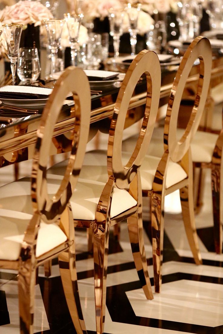 there are many chairs and tables set up for a formal function in the dining room