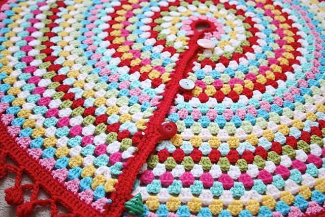 a crocheted umbrella with buttons on it