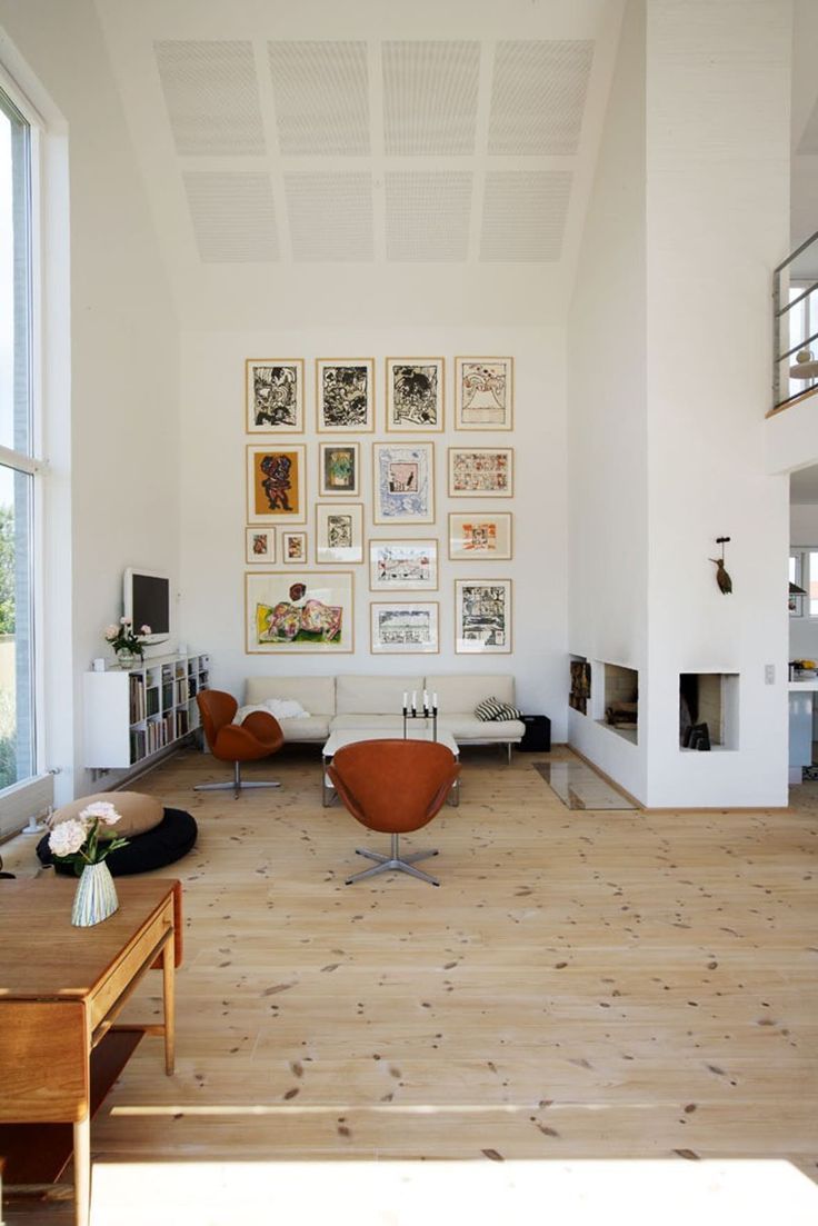 a living room with white walls and wooden floors