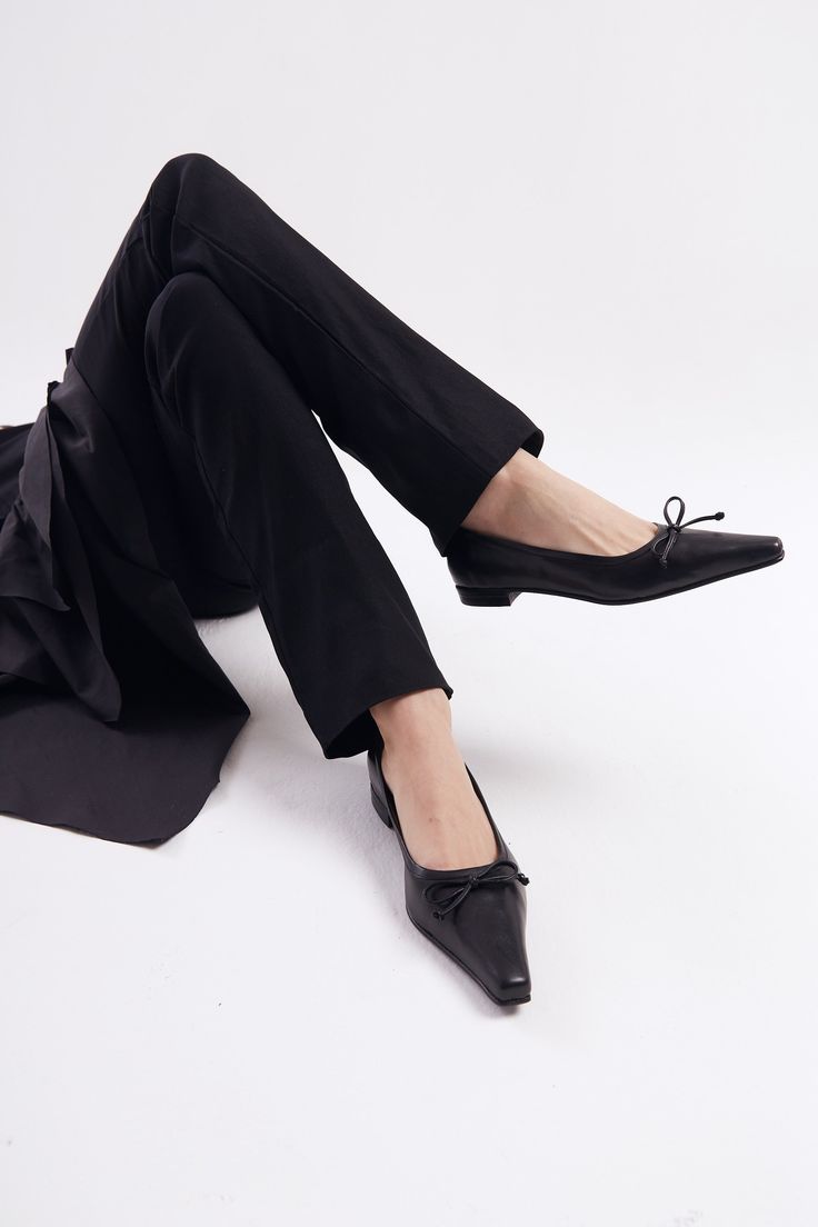 The Ema Bow Flat is the ZX interpretation of a classic pointed ballet silhouette. With a toe that is both pointed and squared, this style will express understated femininity and add refinement to daytime outfits. The Ema will feel as natural with a pair of 501s and tshirt as it does with trousers and a button down. Who it’s for: The woman who takes heavy style inspiration from French new wave films. Kidskin leather upper with vegetable tanned leather lining and a leather sole. Heel height: 18mm Modern Almond Toe Ballet Flats, Elegant Fitted Ballet Flats, Elegant Pointed Toe Formal Flats, Elegant Pointed Toe Fitted Ballet Flats, Elegant Formal Pointed Toe Flats, Elegant Fitted Pointed Toe Ballet Flats, Elegant Fitted Closed Toe Flats, Elegant Business Flats With Low Heel, Classic Evening Ballet Flats With Flat Heel