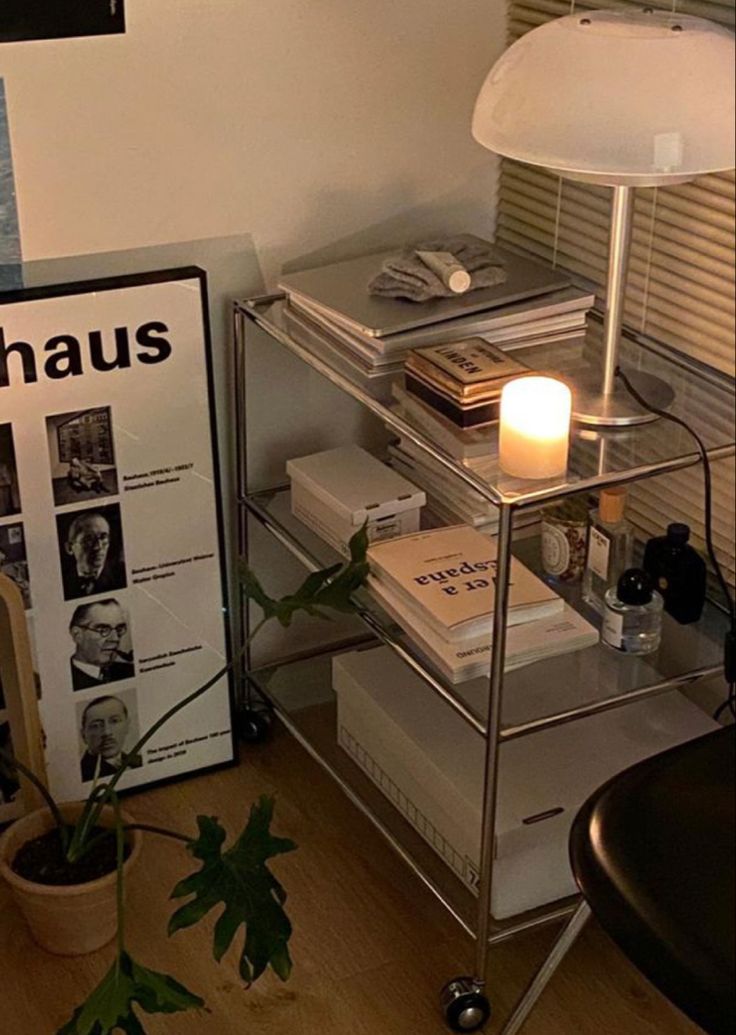 a table with books and a candle on it in front of a sign that says haus