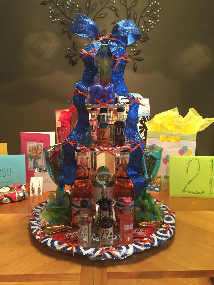 a table topped with lots of bottles of alcohol and gifts on top of each other