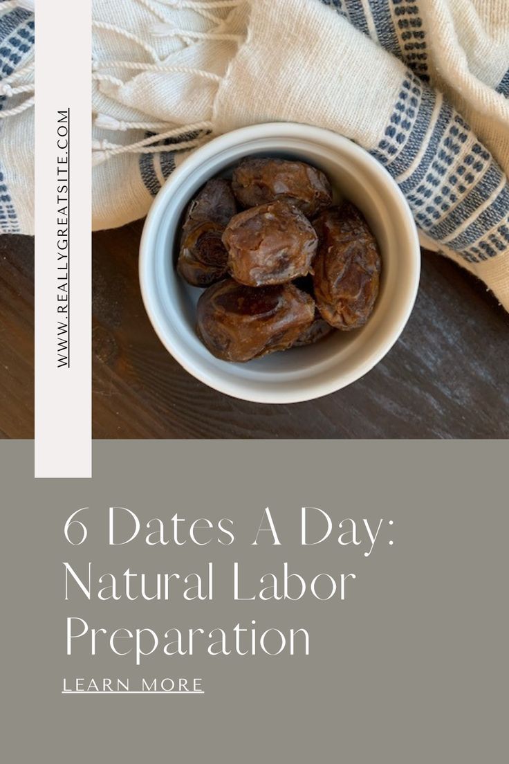 a bowl filled with dates sitting on top of a wooden table next to a cloth