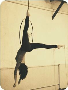 a woman doing aerial acrobatics on a hoop