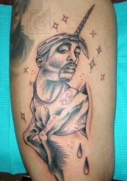 an image of a unicorn tattoo on someone's leg