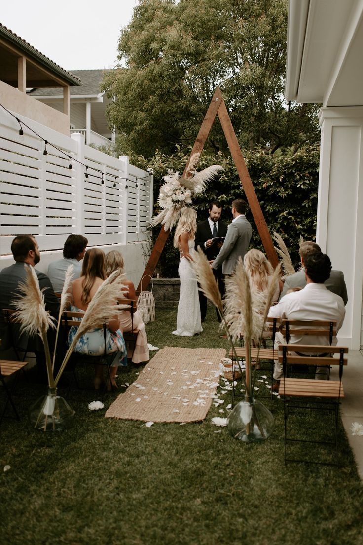 a couple getting married at their backyard wedding