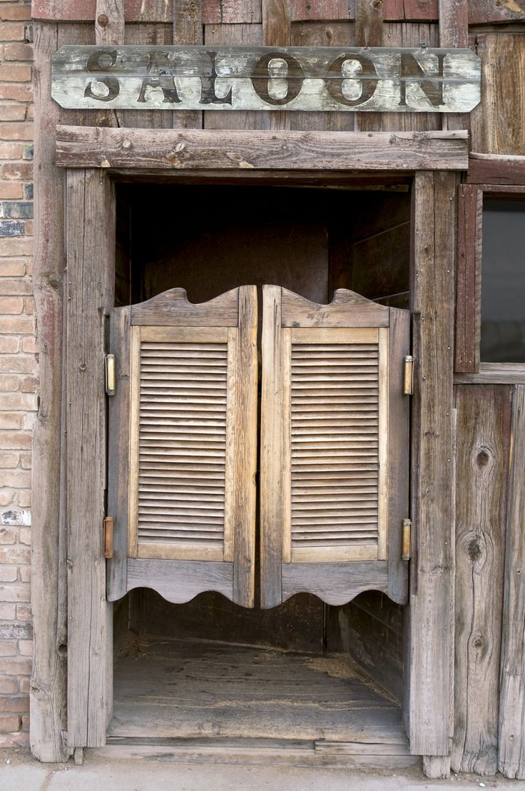 an old wooden door with shutters open