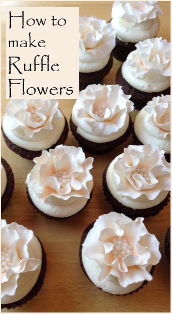 several cupcakes with white frosting and flowers on them