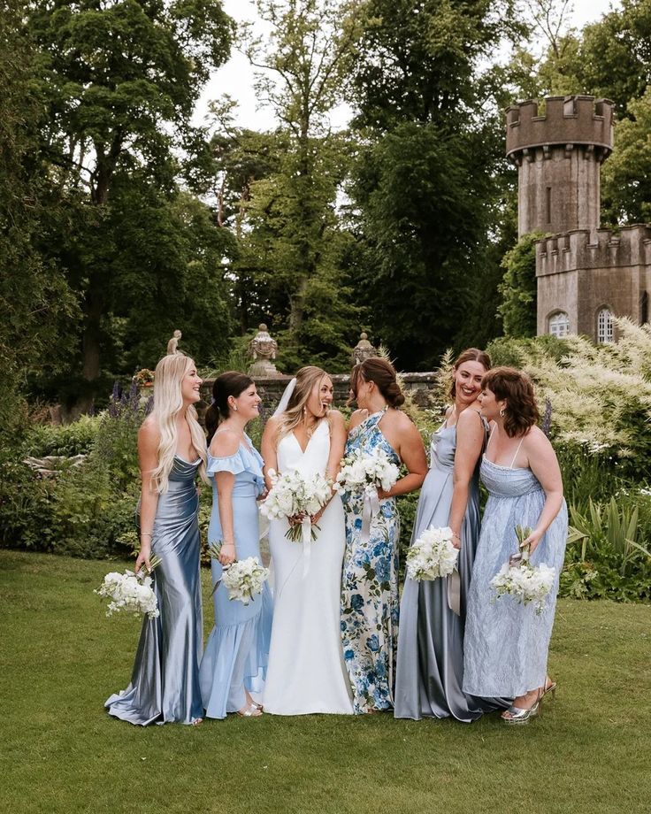 a group of women standing next to each other on top of a lush green field